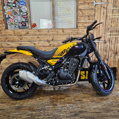 Motorcycle with visible branding on a wooden wall