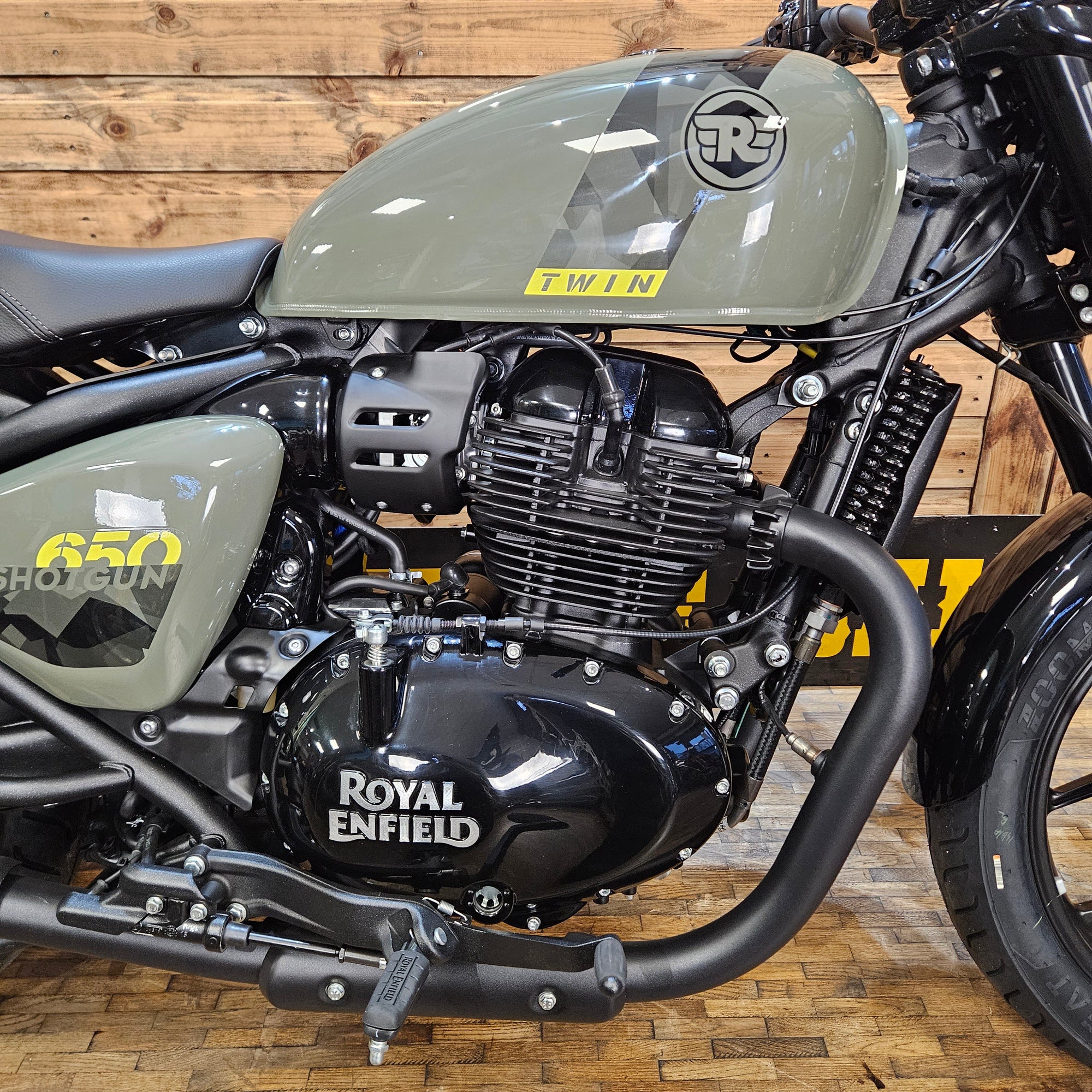 Close-up of a Royal Enfield motorcycle engine on a wooden background