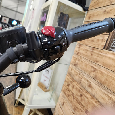 Close-up of a bicycle handlebar with a wooden floor background