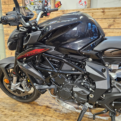 Black motorcycle on a wooden floor