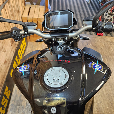 Motorcycle on a wooden platform with a brick wall background