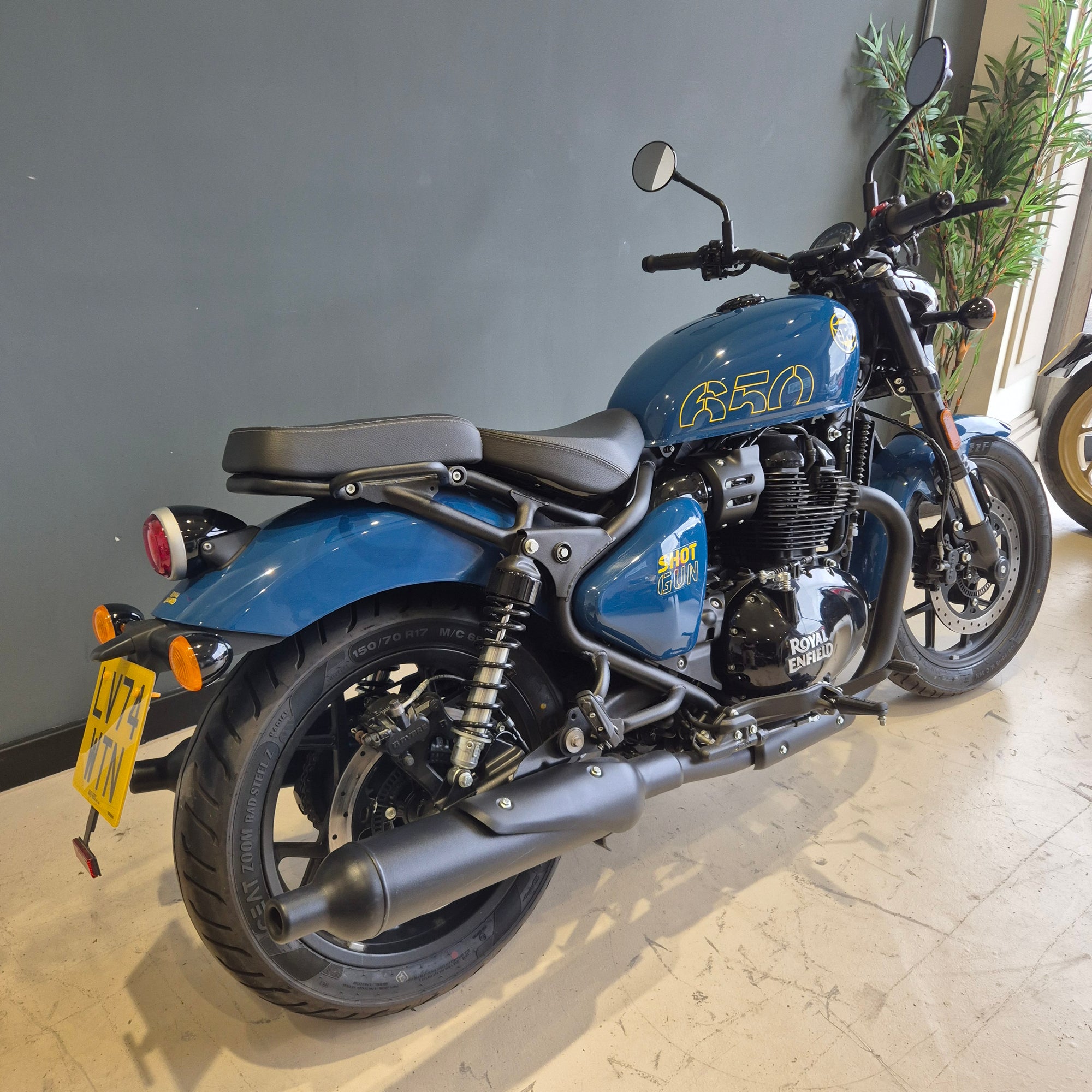 Blue motorcycle on a stand indoors