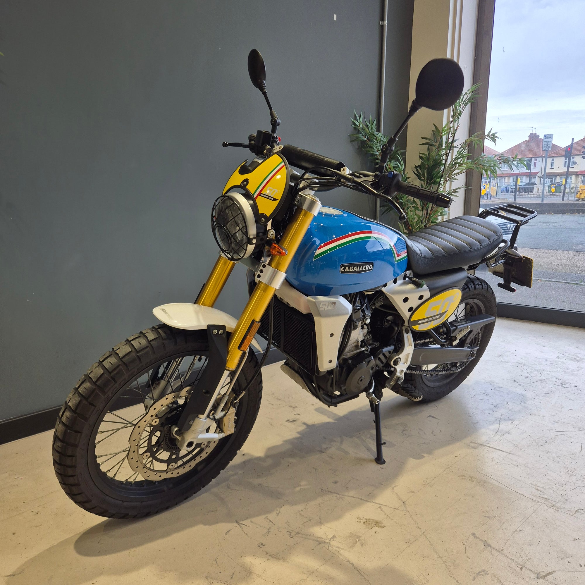 Motorcycle with colorful design parked on a concrete surface.