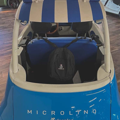 Blue and beige electric vehicle with a striped canopy and a black bag inside, brand 'MICROLINQ' visible.