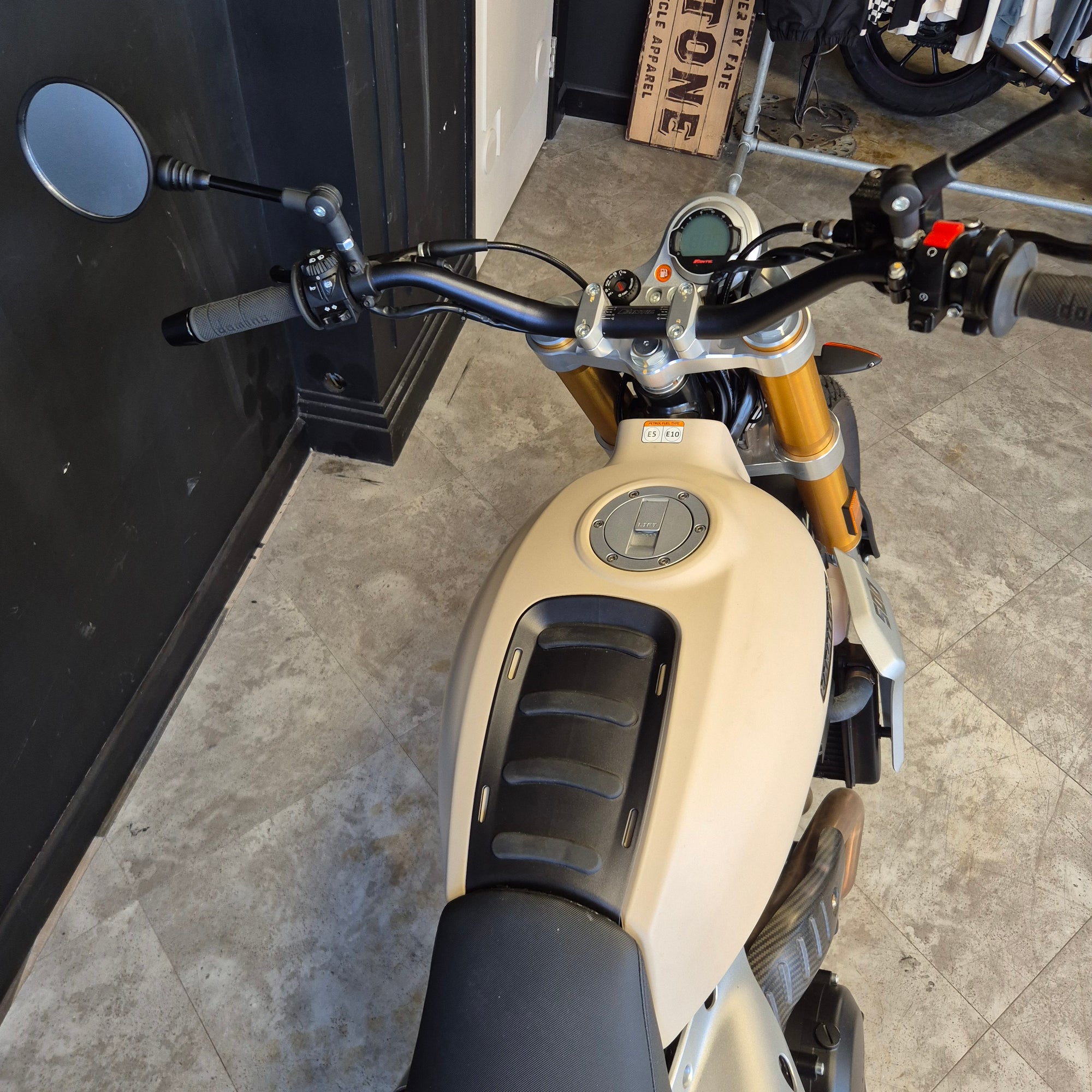 Close-up of a motorcycle handlebar with a neutral background