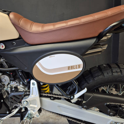 Close-up of a motorcycle with a brown seat and visible brand logo.