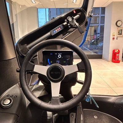 Steering wheel and dashboard of a vehicle inside a showroom