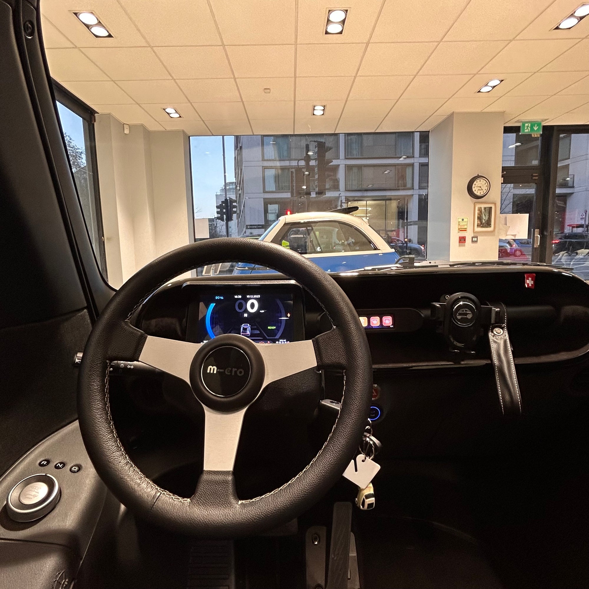 Steering wheel and dashboard of a vehicle in a showroom setting