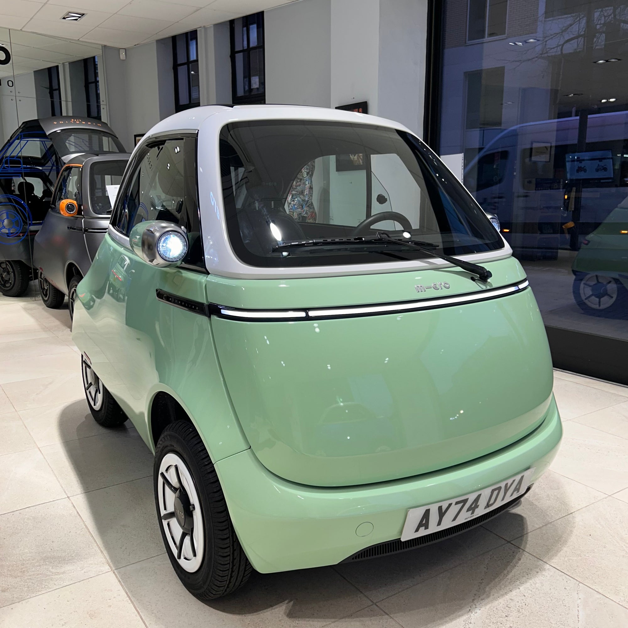 Small electric car on display in a showroom