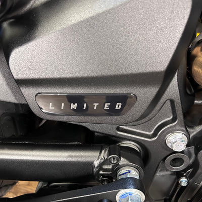Close-up of a motorcycle with a 'LIMITED' badge on a metallic surface.