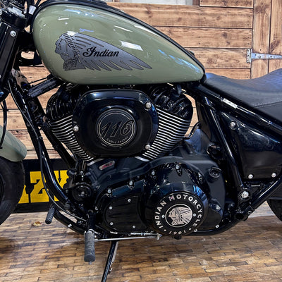 Close-up of an Indian motorcycle engine with a wooden background