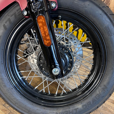 Close-up of a motorcycle wheel with a visible brand name on the rim.