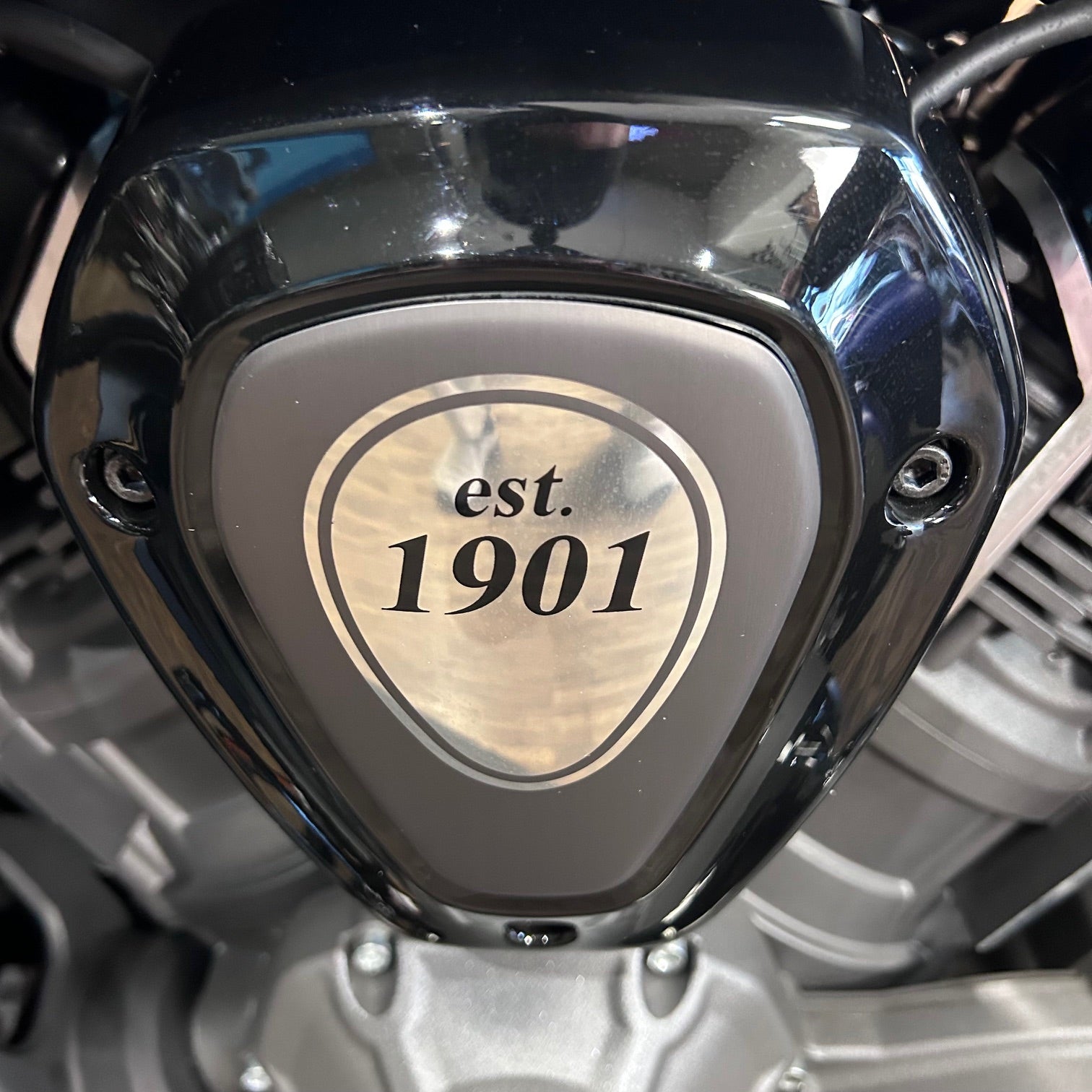 Motorcycle headlight with 'est. 1901' branding
