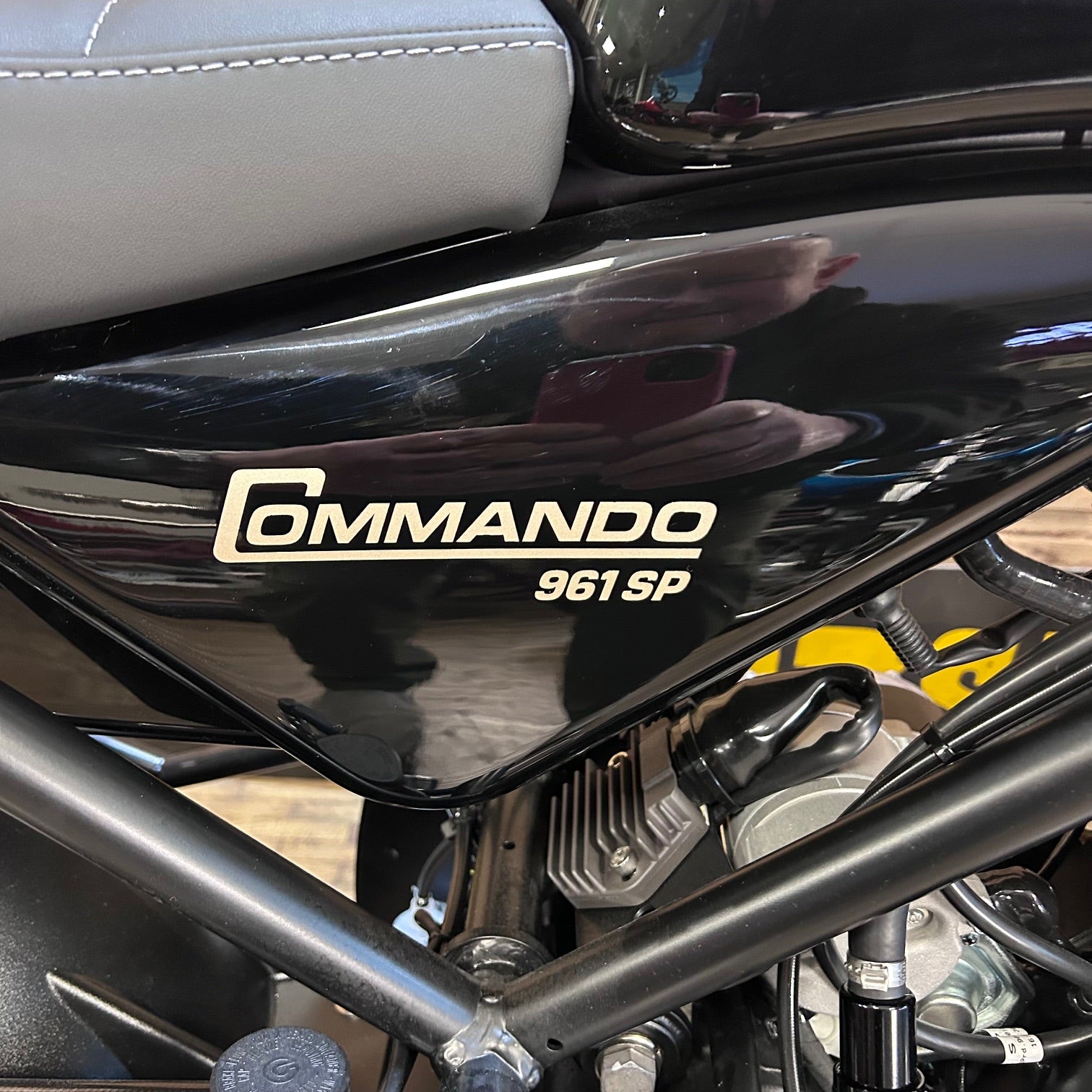 Close-up of a motorcycle with 'Commando 961 SP' branding on the fuel tank.