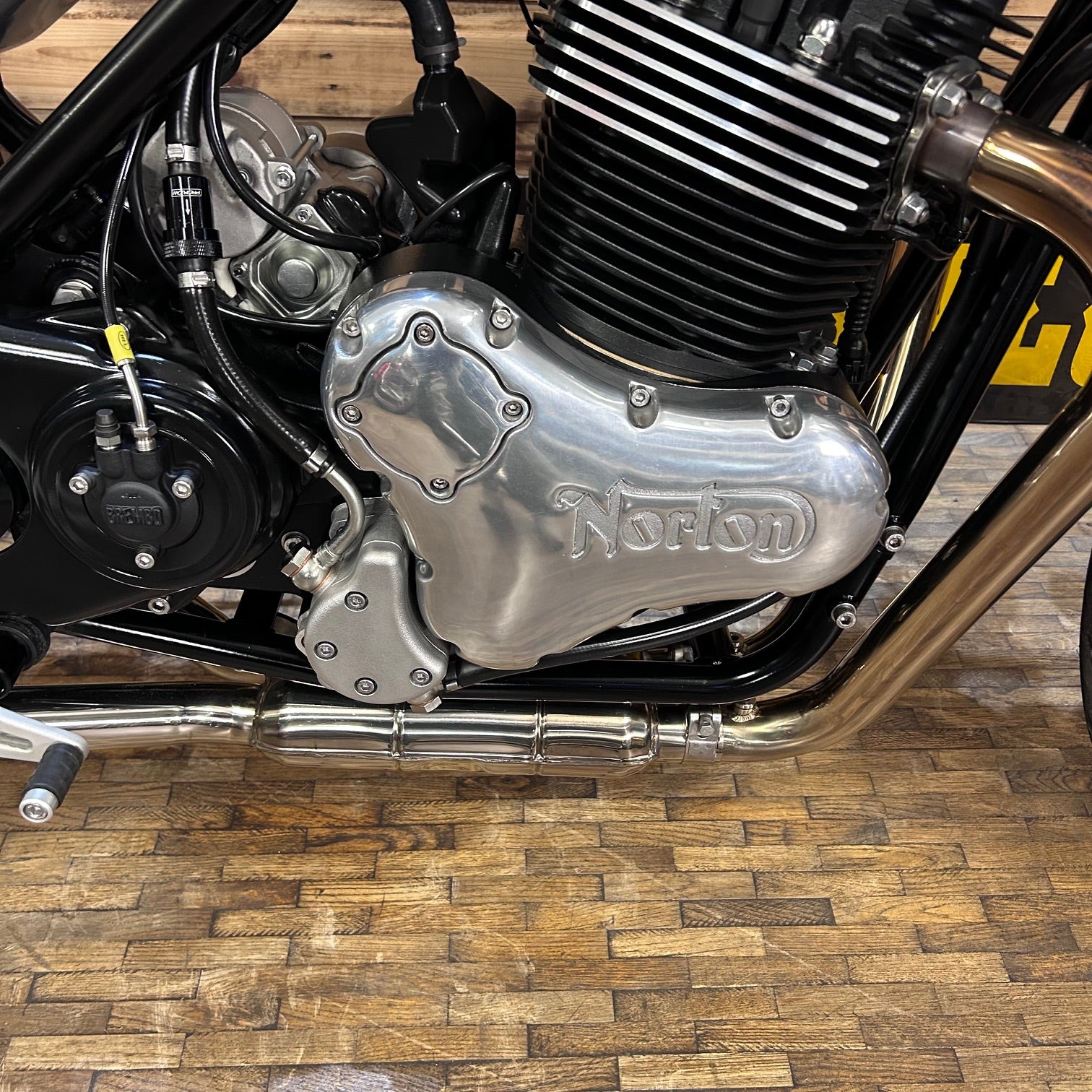 Close-up of a Norton motorcycle engine on a wooden floor