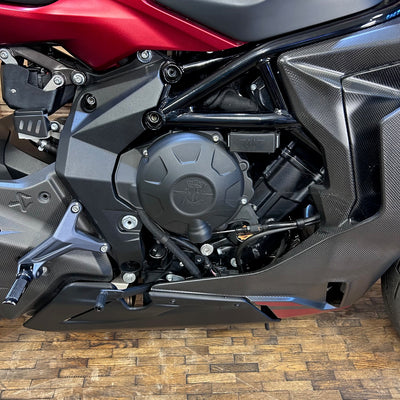 Close-up of a motorcycle engine on a wooden floor