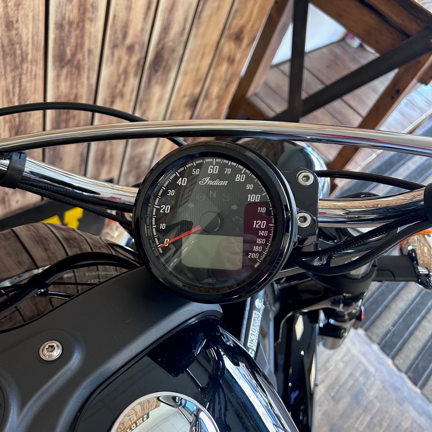 Motorcycle speedometer with wooden background