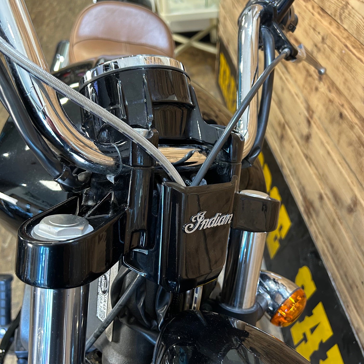 Close-up of an Indian motorcycle handlebar with a blurred background
