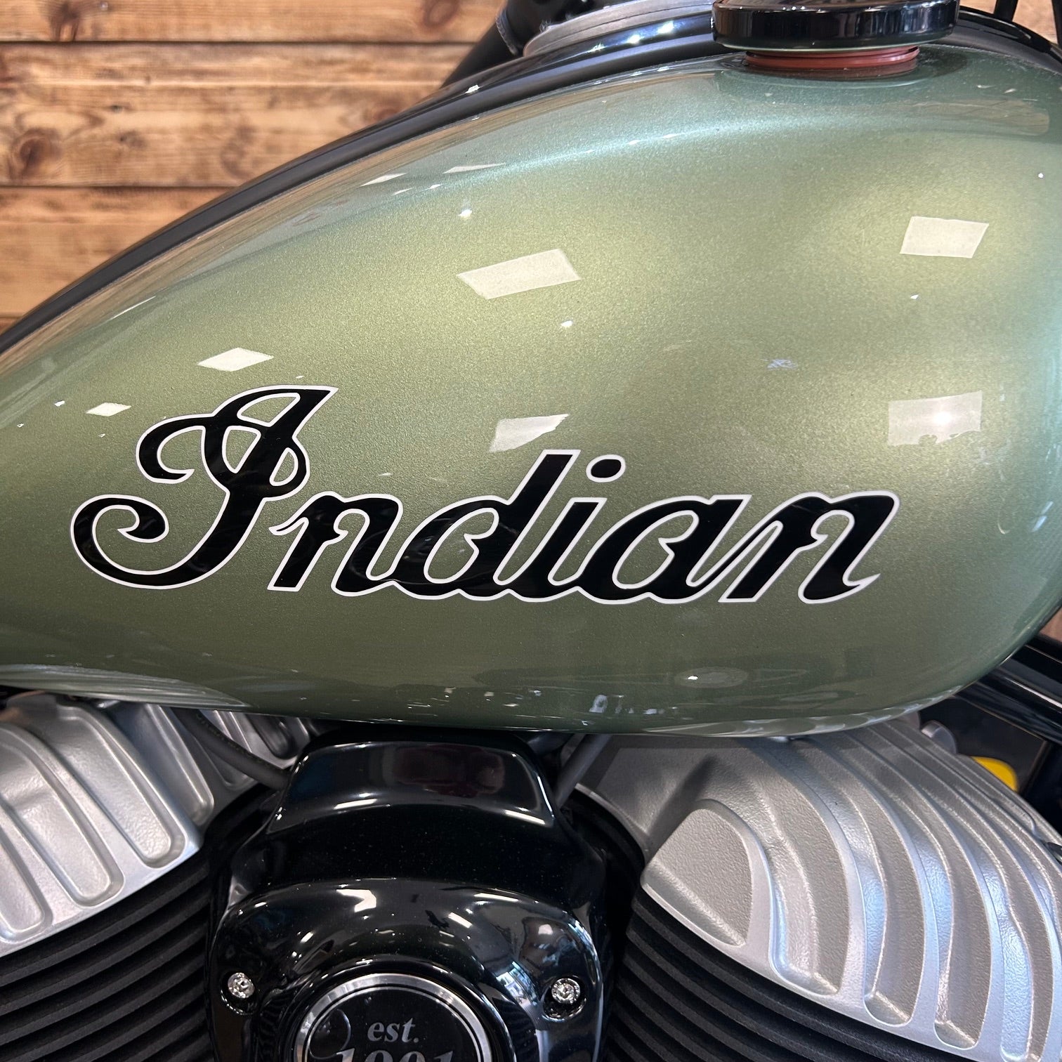 Close-up of a motorcycle fuel tank with 'Indian' branding.