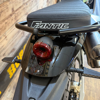 Close-up of a motorcycle with 'Fantic' branding on the seat.