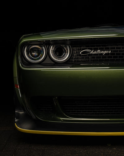 Front view of a green Dodge Challenger car on a black background