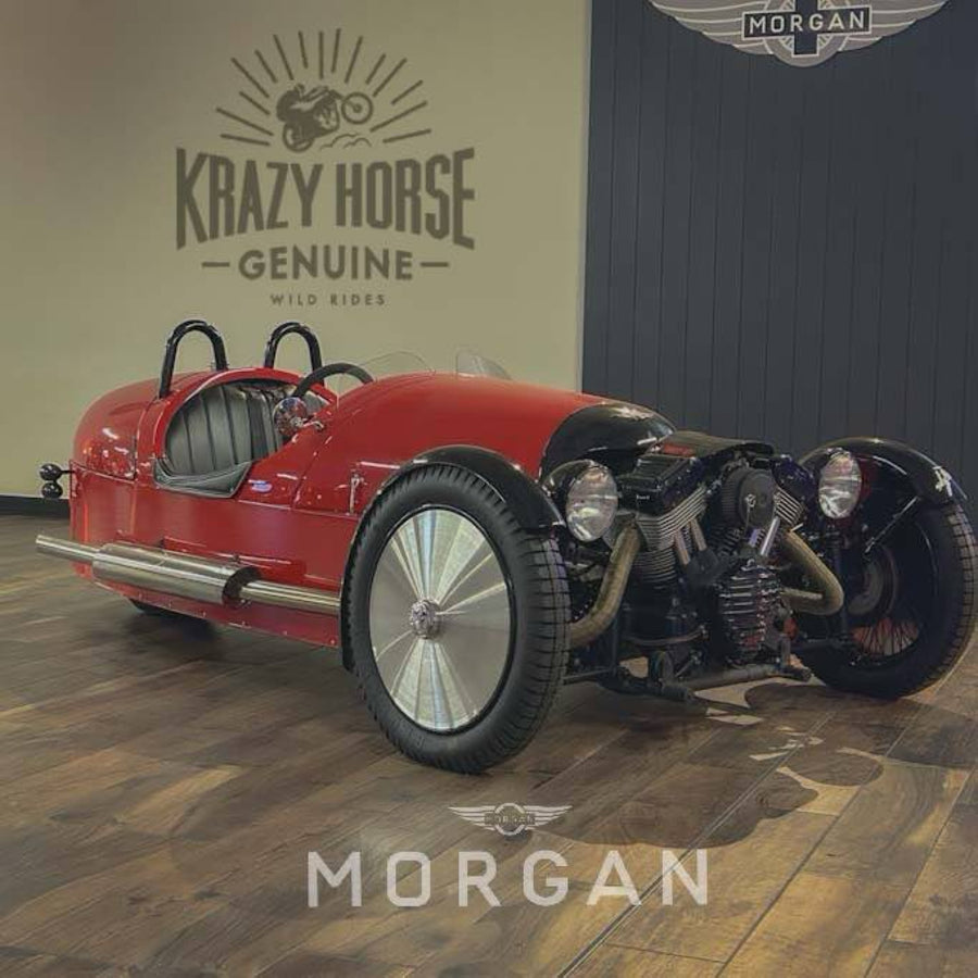 Red vintage-style car on a wooden floor with 'Krazy Horse' and 'Morgan' branding.