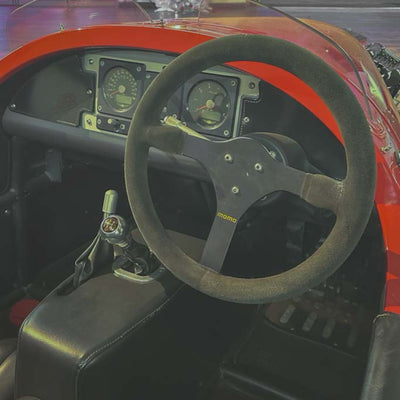 Steering wheel with MOMO logo in a car interior