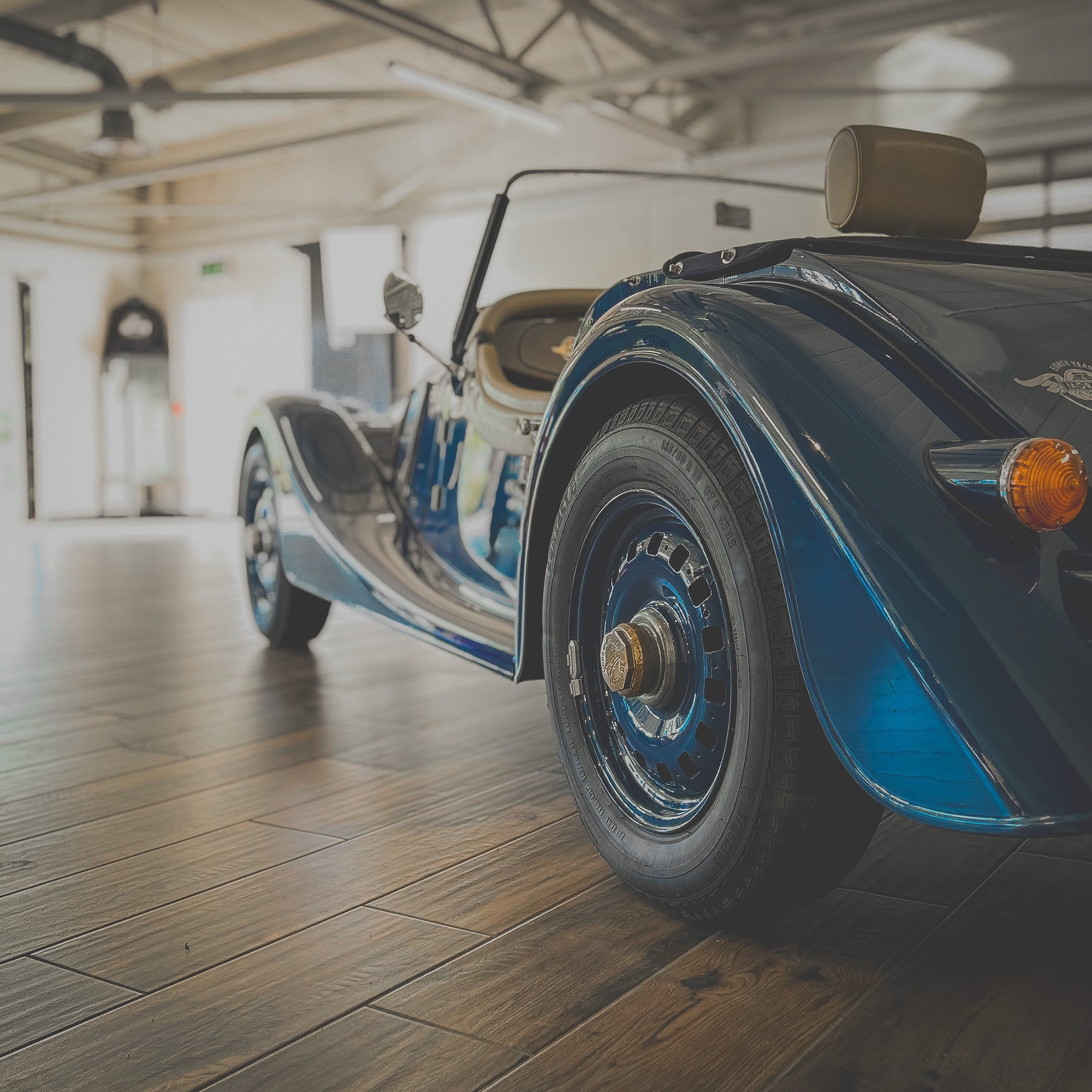 Vintage car on a wooden floor in a garage