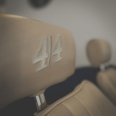 Close-up of a car seat with '44' embossed on it, blurred background