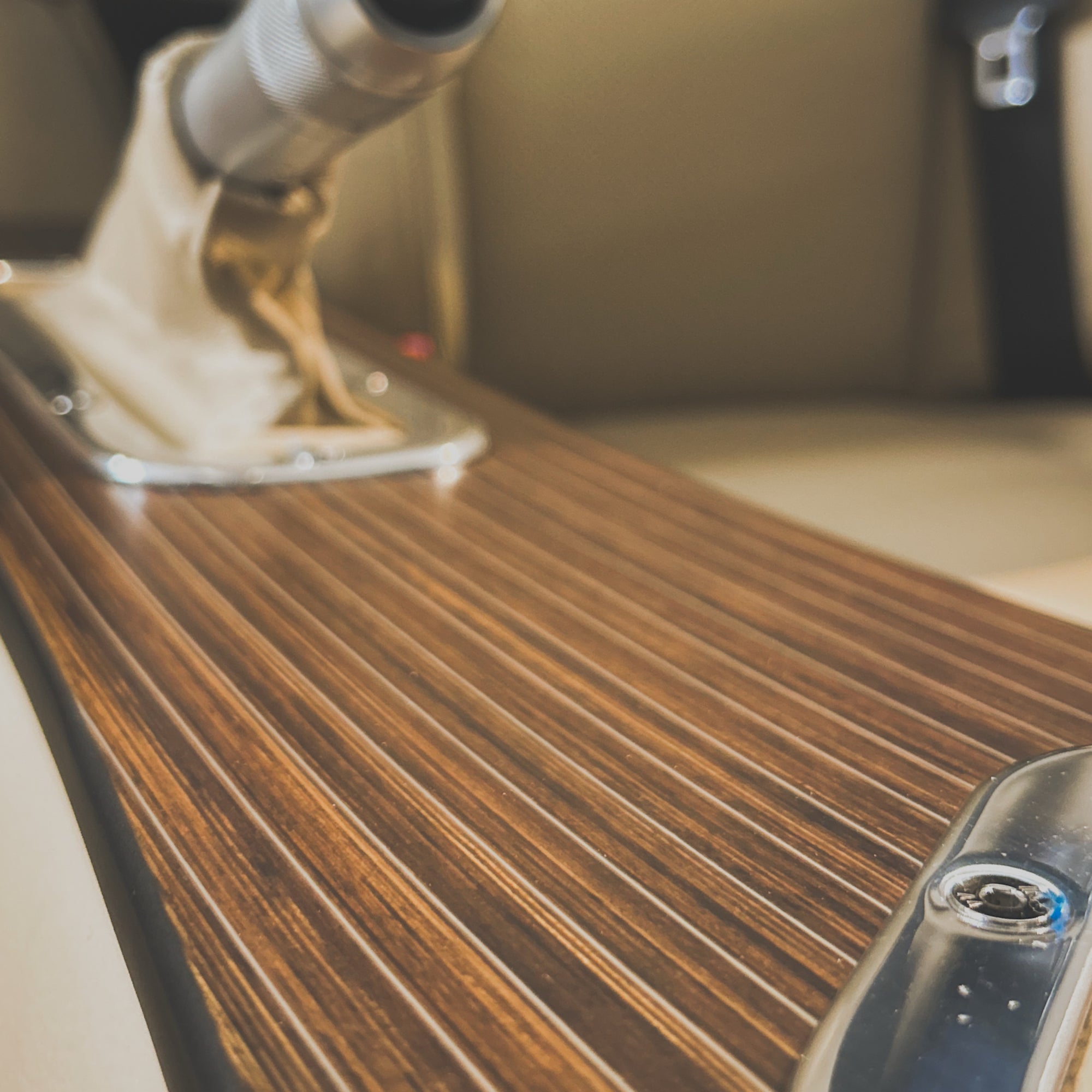 Close-up of a wooden dashboard with a focus on texture and finish.