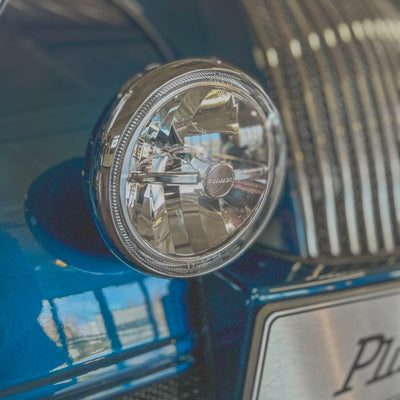Close-up of a car headlight with a blurred background