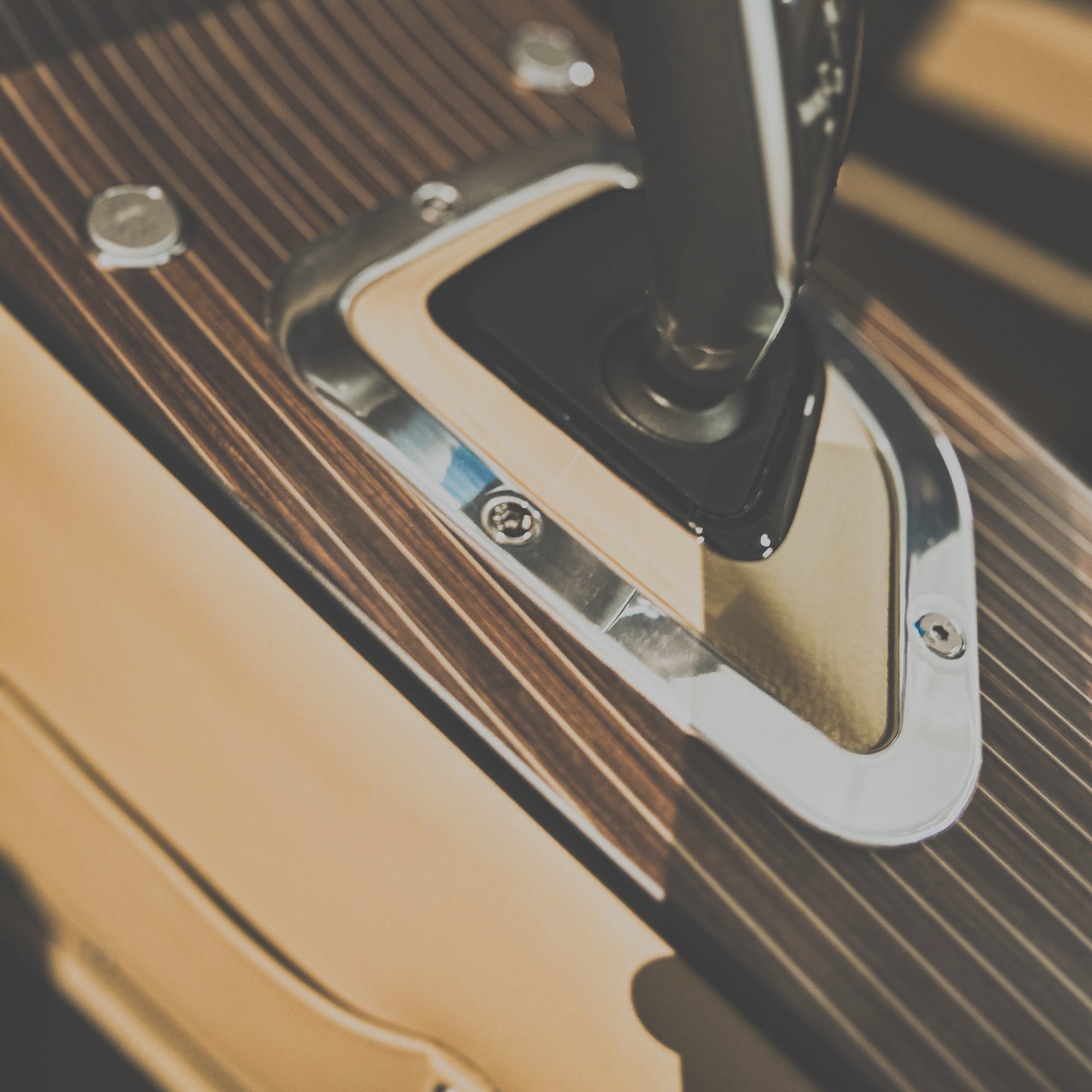 Close-up of a metallic door handle on a wooden surface