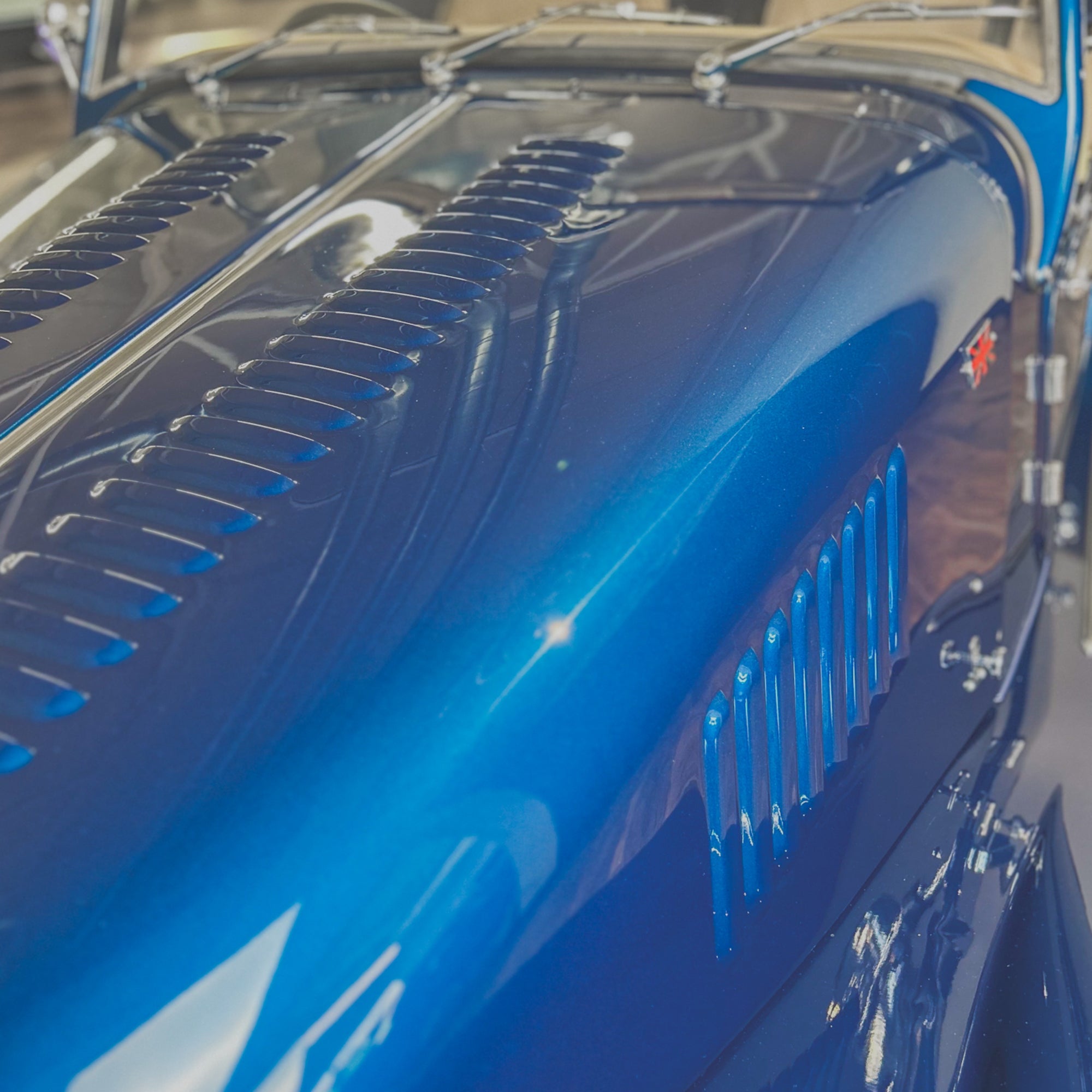 Close-up of a blue car's grille and hood