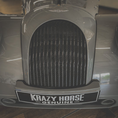 Close-up of a car grille with 'Krazy Horse Genuine' branding.