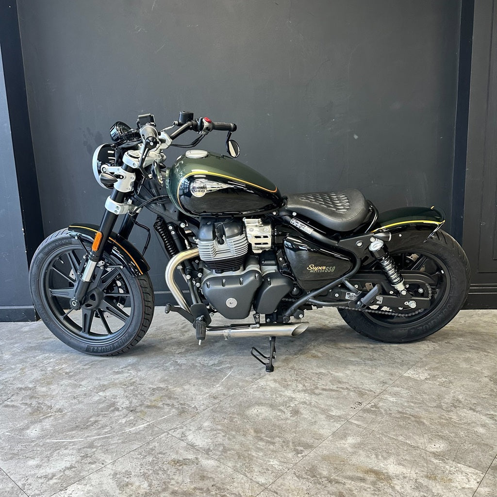Motorcycle parked indoors with a dark background