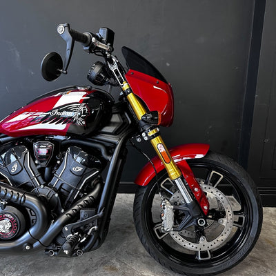 2025 Indian Scout 101 – SUNSET RED METALLIC WITH GRAPHICS- PRELOVED  Red and black motorcycle with gold accents on a dark background