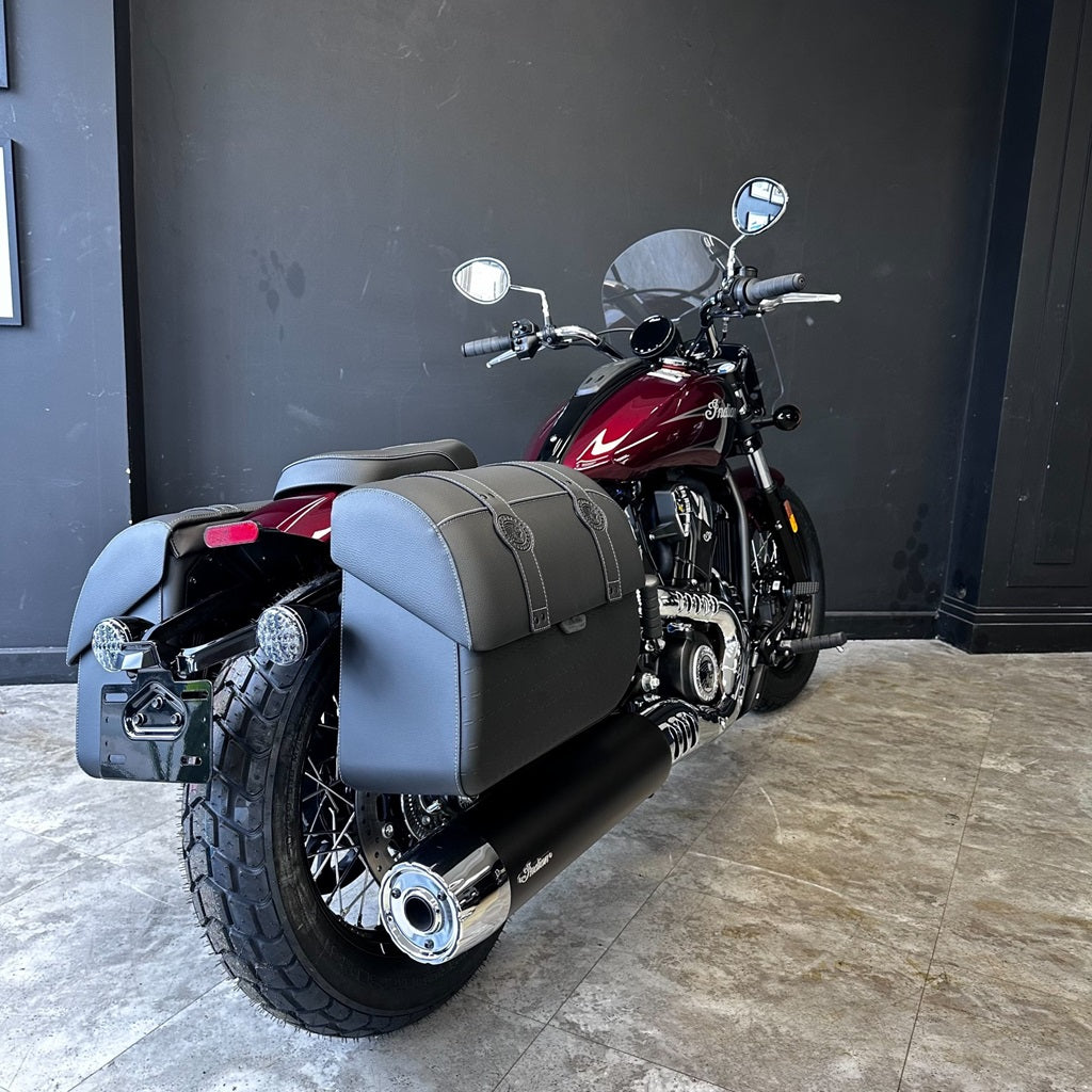 Motorcycle with sidecar on a tiled floor against a dark wall