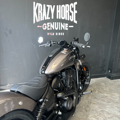 A matte dark gray Kawasaki Starlight cruiser motorcycle parked indoors against a dark wall with 'KRAZY HORSE GENUINE' branding.