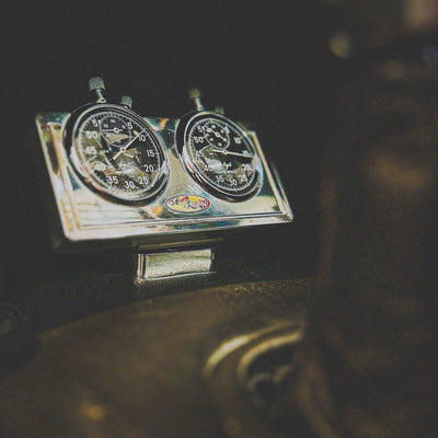 Vintage car dashboard with speedometer and tachometer on a dark background