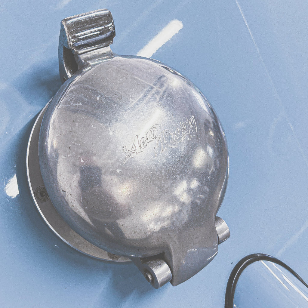 Metallic object with 'Waltham' branding on a blue background