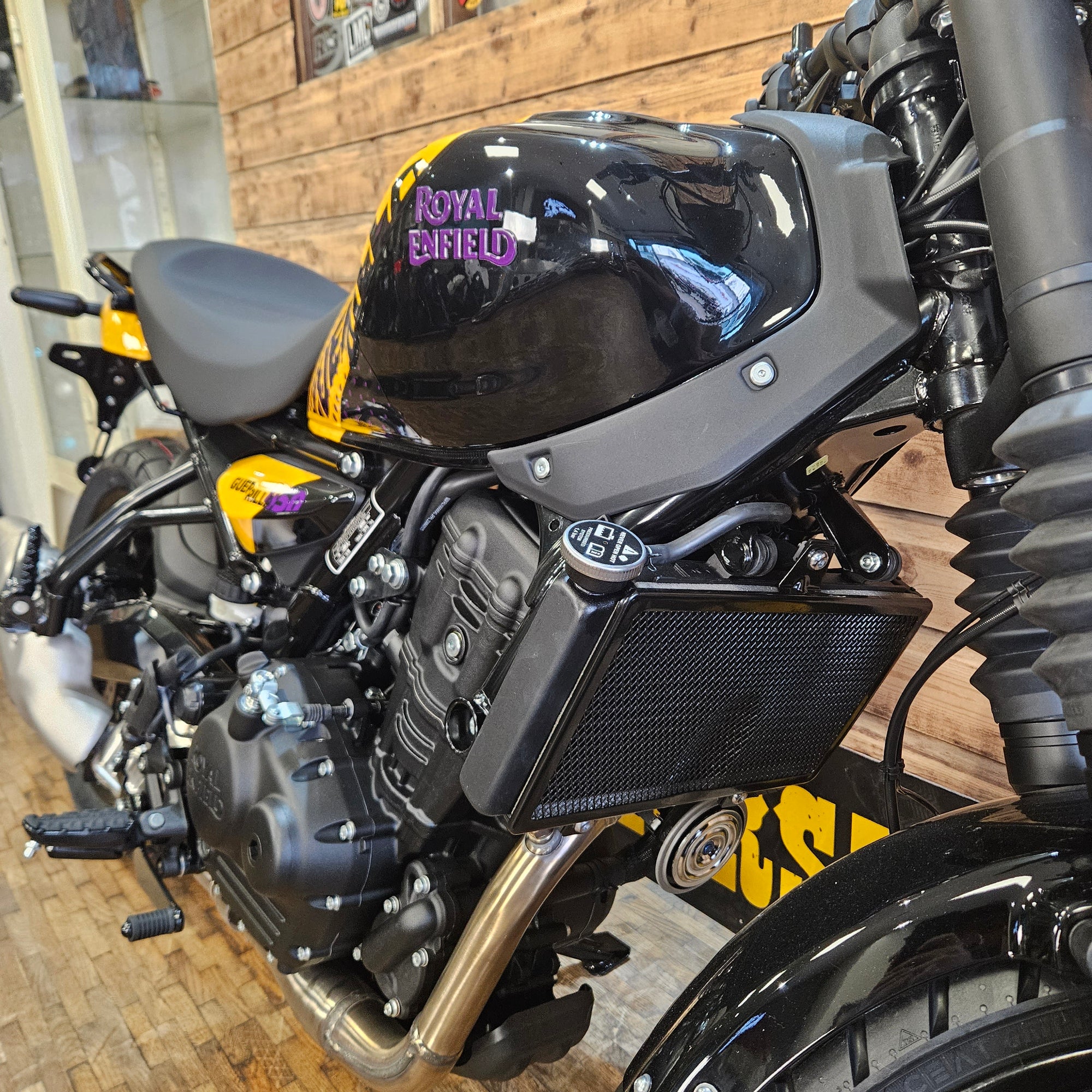 Close-up of a motorcycle engine with visible branding on a blurred background