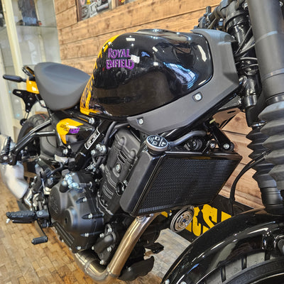 Close-up of a motorcycle engine with visible branding on a blurred background