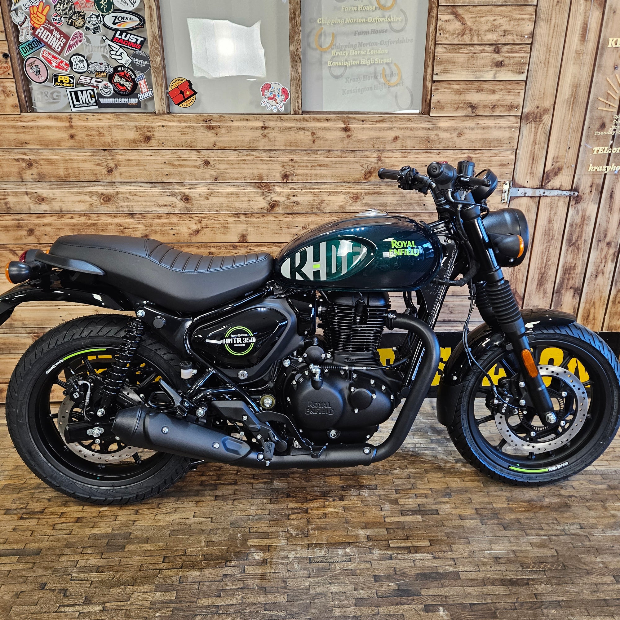 Motorcycle leaning against a wooden wall with decorative elements