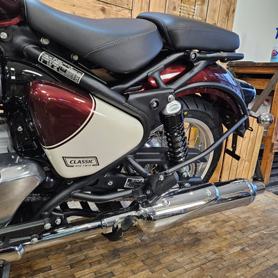 Close-up of a motorcycle with a visible brand logo on a wooden surface.