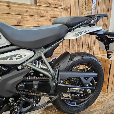 Close-up of a motorcycle's rear section on a wooden deck