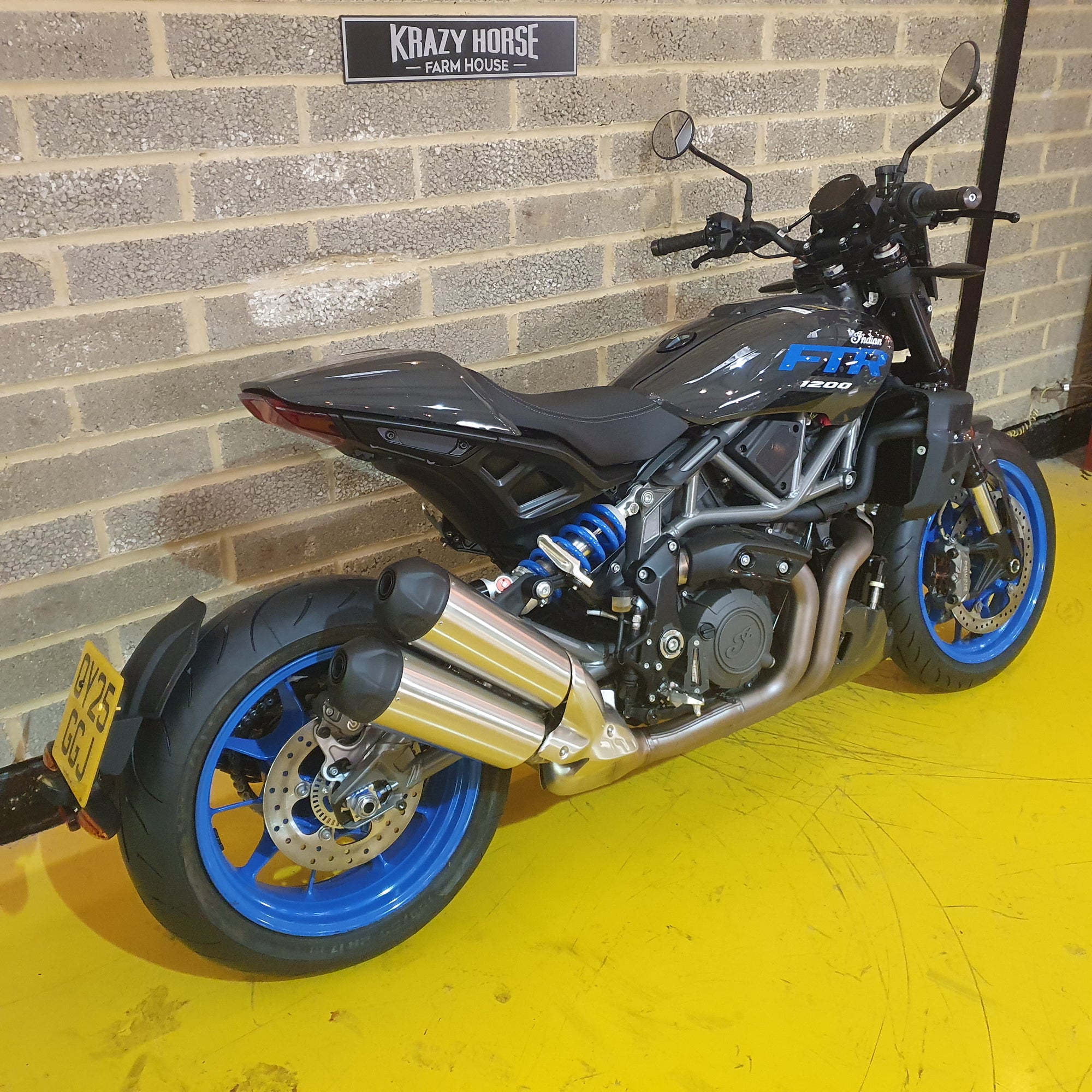 Indian FTR Motorcycle parked against a brick wall with 'Krazy Horse' branding.