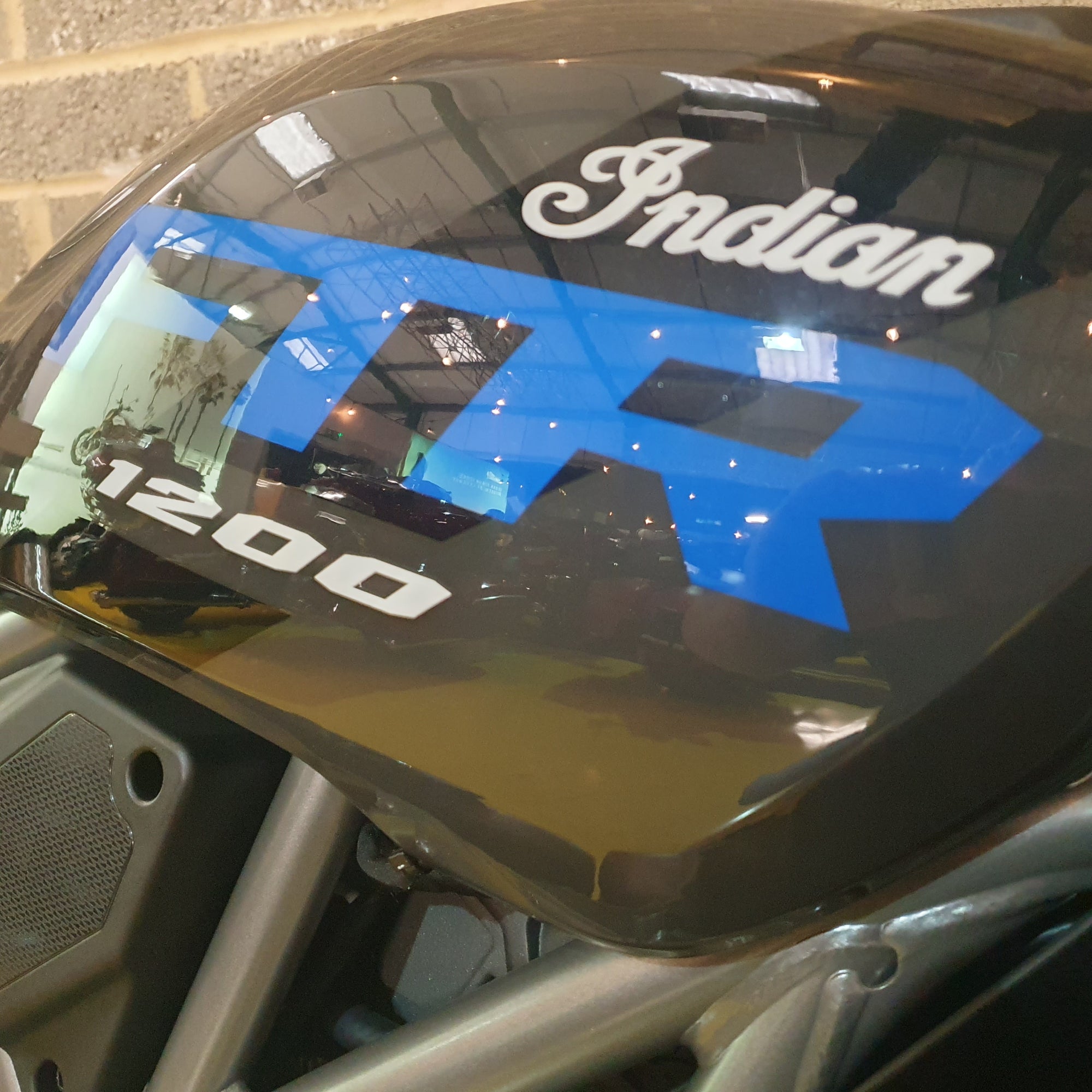 Motorcycle with 'Indian' branding on a reflective surface