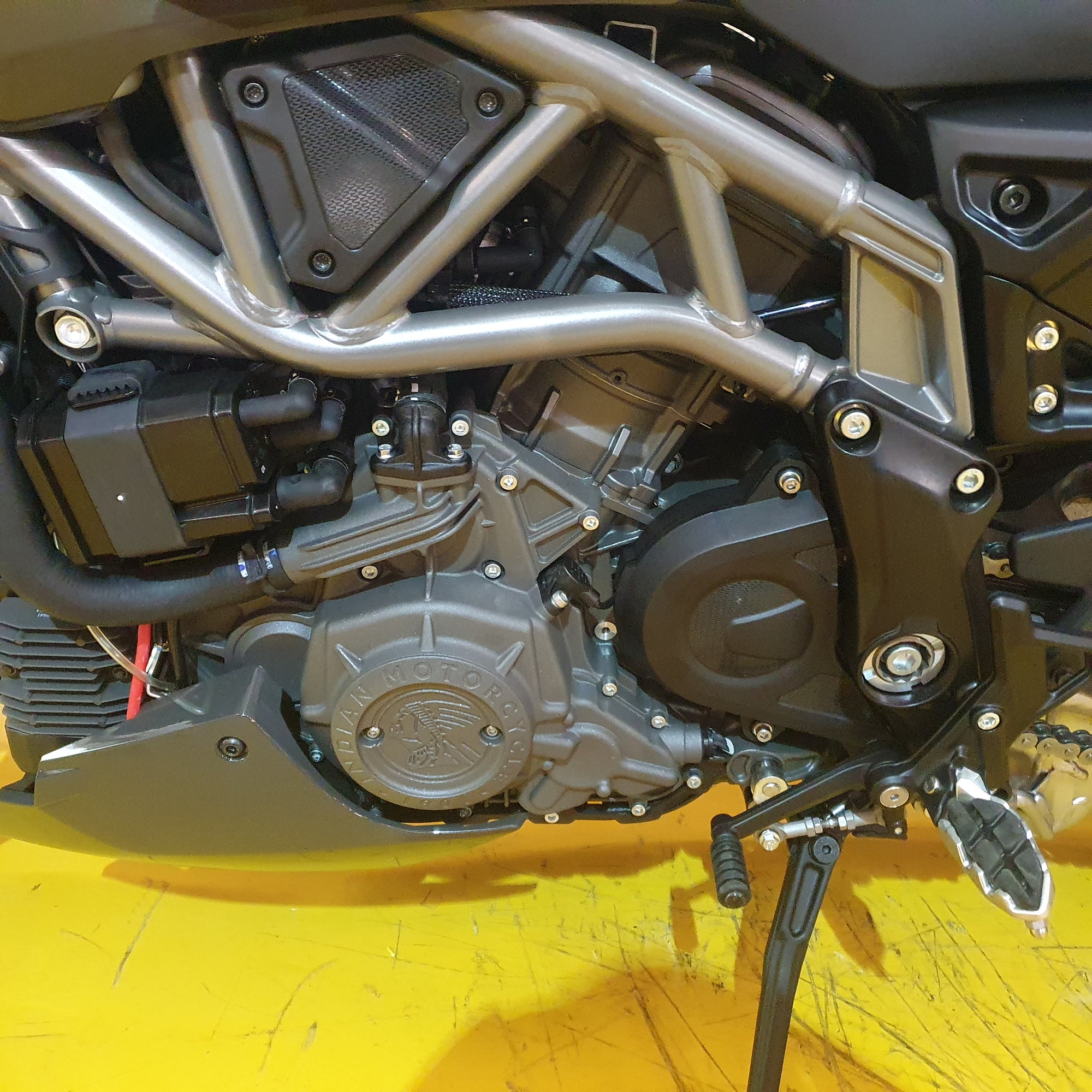 Close-up of a motorcycle engine on a yellow background