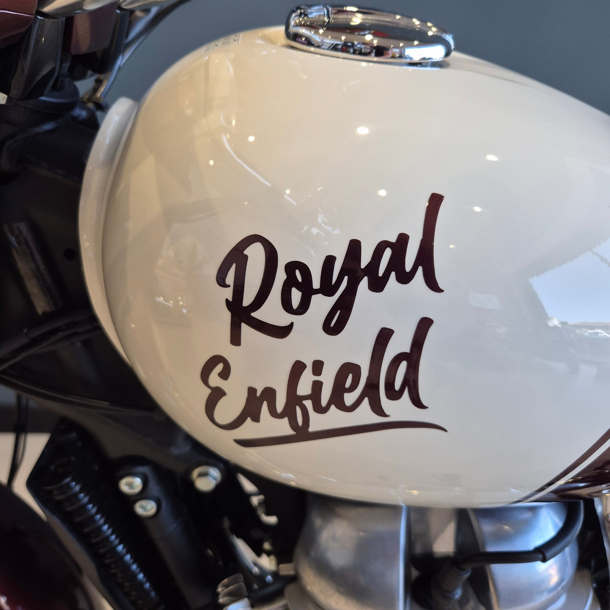 Close-up of a motorcycle with 'Royal Enfield' branding on the headlight.