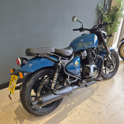 Blue motorcycle on a stand indoors